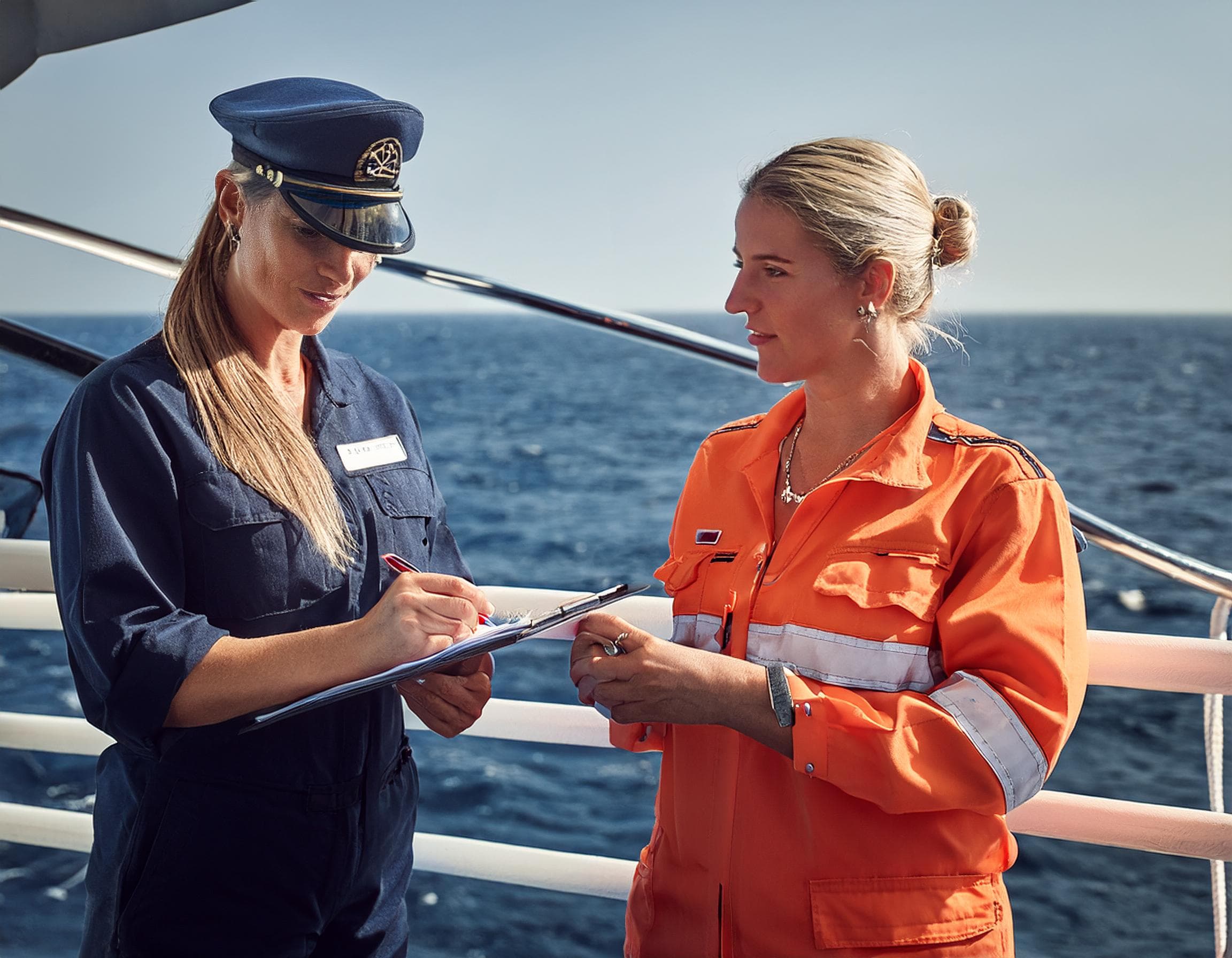 Ship agent assisting crew member with onboarding paperwork